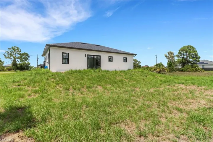 Rear view of property with stucco siding