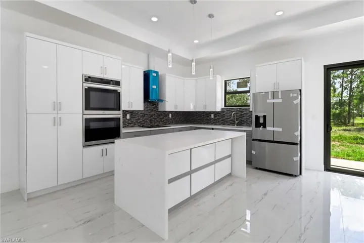 Kitchen with appliances with stainless steel finishes, decorative backsplash, healthy amount of natural light, and recessed lighting