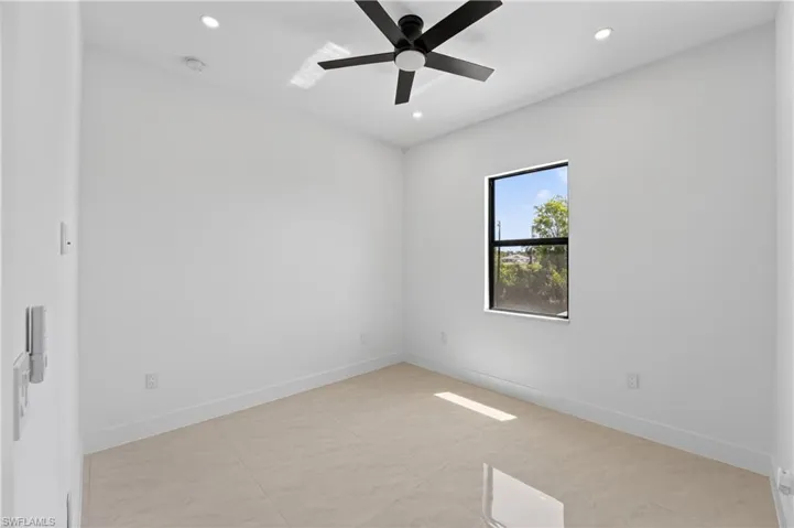 Walk-in shower featuring a ceiling-mounted rainfall showerhead and a wall-mounted square showerhead