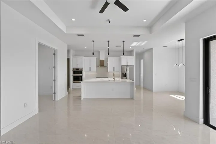 Open-concept interior featuring large format tile flooring throughout