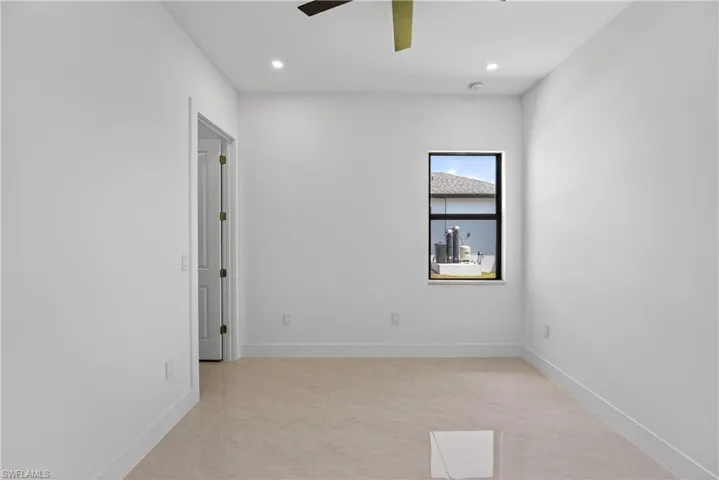 Neutral-toned tile flooring complements the white walls and trim