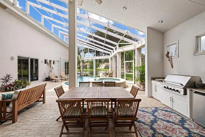Lanai view with built in kitchen and teak furniture