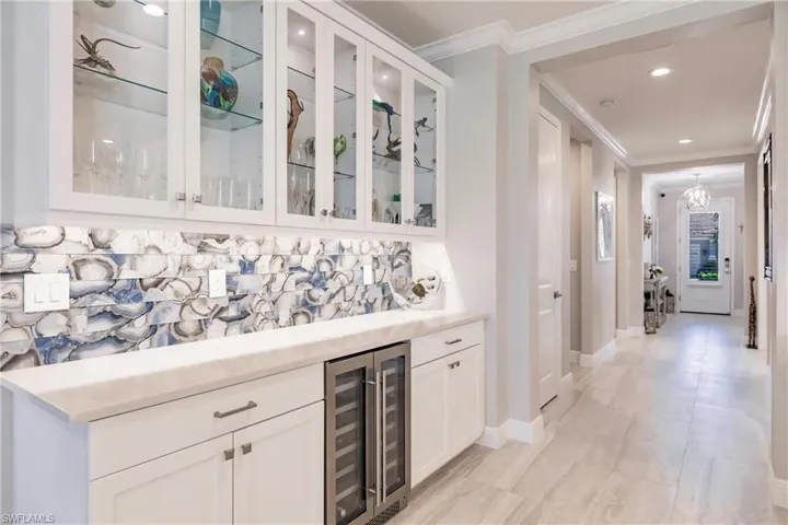 Complete bar with wine cooler and glass display cabinetry. New glass agate backsplash!