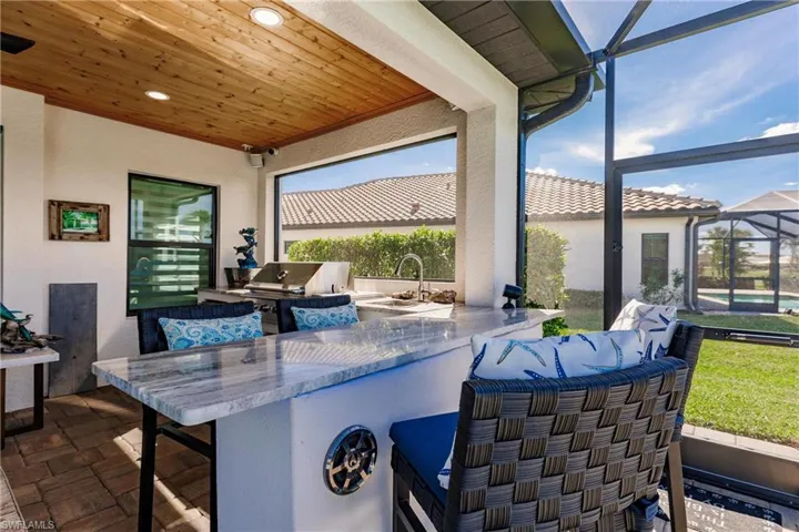 Custom bar open to the pool and spa