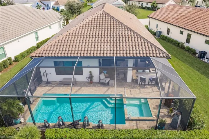 Generous screened lanai, pool and spa overlooking the fairway are great for entertaining  entertaining