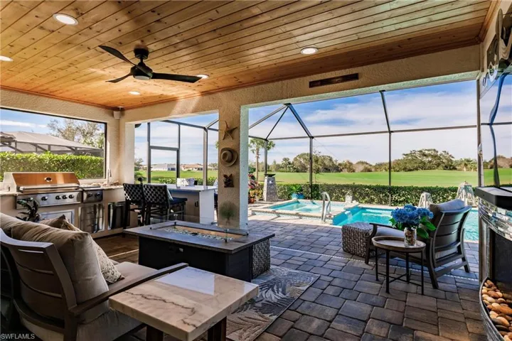 Custom outdoor kitchen with granite bar for entertaining