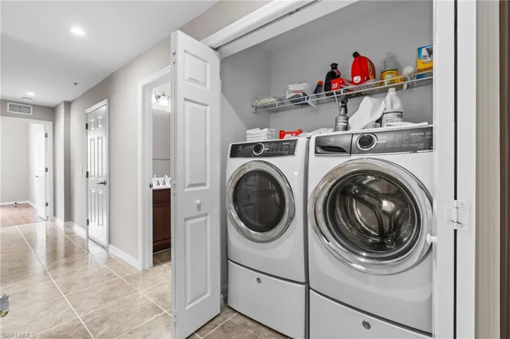 Laundry area with visible vents, recessed lighting, washer and dryer, laundry area, and light tile patterned floors
