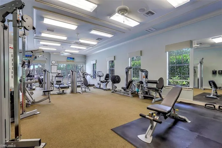 Workout area with visible vents, a wealth of natural light, and ornamental molding