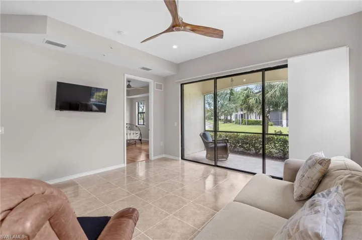 Living room with recessed lighting, visible vents, light tile patterned flooring, baseboards, and ceiling fan