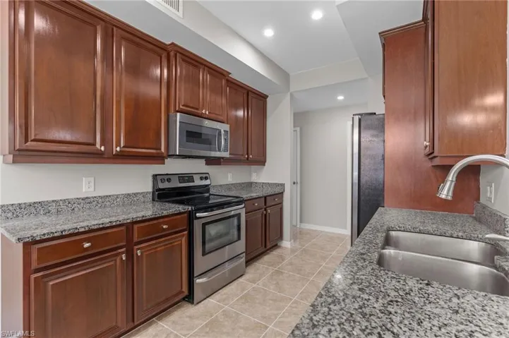 Kitchen featuring recessed lighting, visible vents, a sink, light tile patterned flooring, and appliances with stainless steel finishes