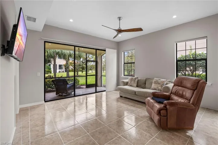 Tiled living area featuring baseboards, visible vents, recessed lighting, and ceiling fan