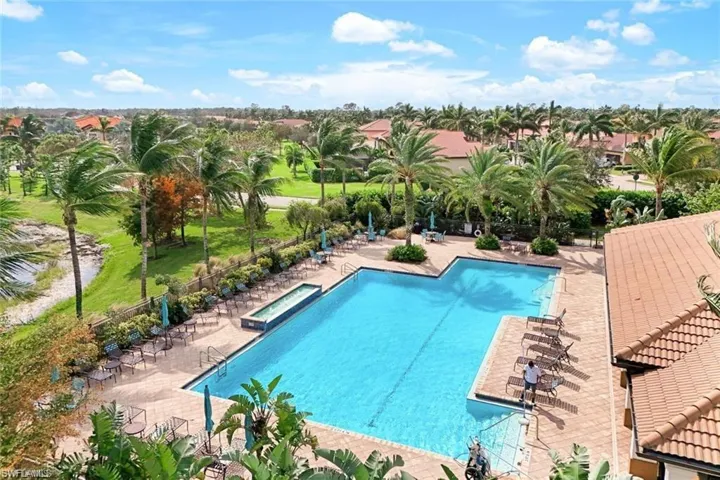 Pool featuring a patio area, a hot tub, and fence