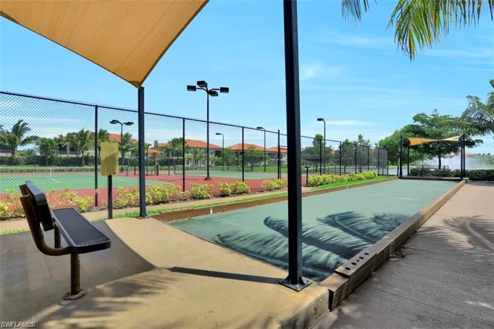 Surrounding community featuring fence and a tennis court