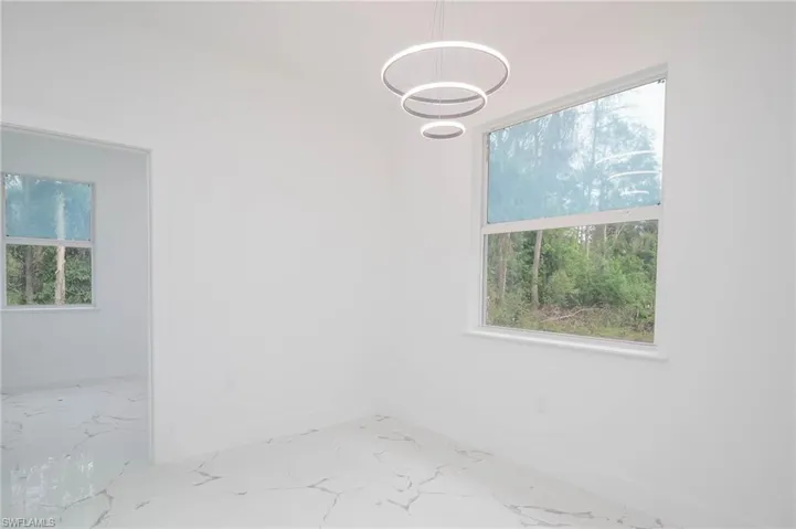Empty room with baseboards and marble finish floors