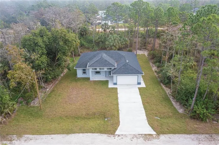View of subject property featuring a heavily wooded area