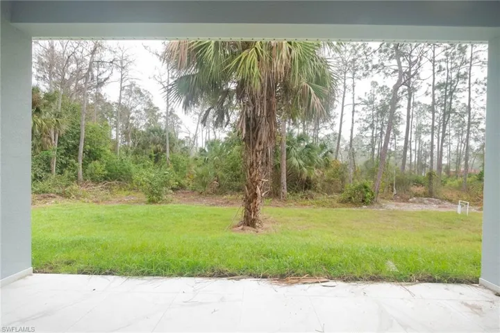 View of green lawn featuring a patio area