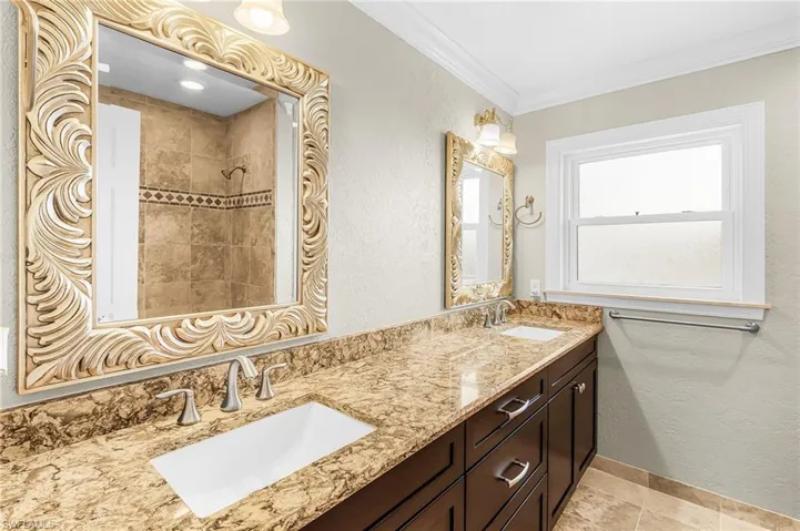 Dual vanity with stone-finish countertops and integrated rectangular sinks