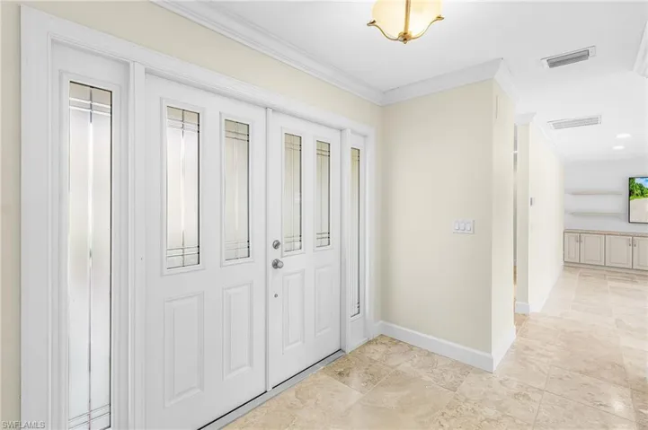 Double entry doors with decorative glass inserts and side lites