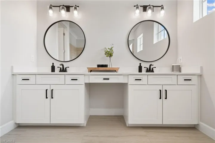 Bathroom with plank tile flooring and double sink vanity