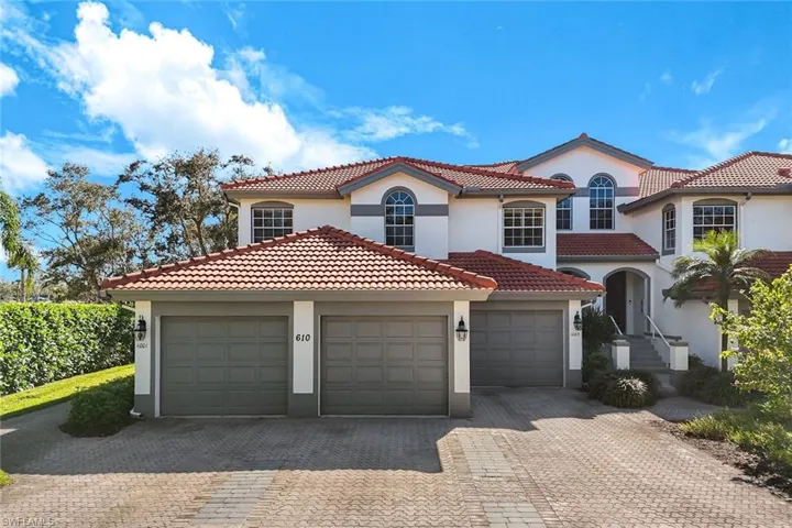 Mediterranean / spanish-style home featuring stucco siding, driveway, a garage, and a tiled roof