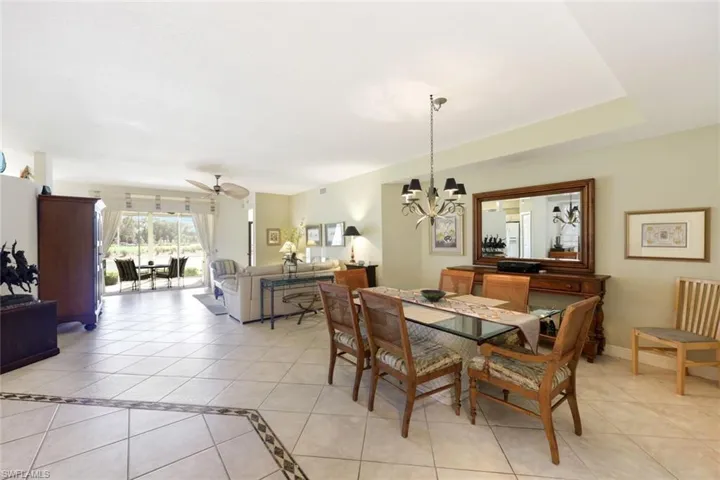 Dining room featuring light tile patterned floors, a ceiling fan, and a chandelier