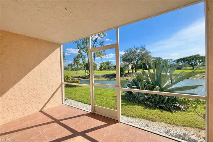 Unfurnished sunroom featuring a water view