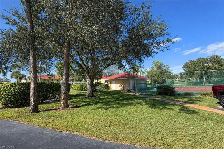 View of yard featuring a tennis court
