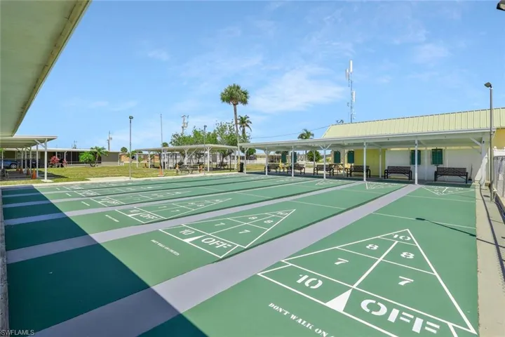 View of home's community featuring shuffleboard