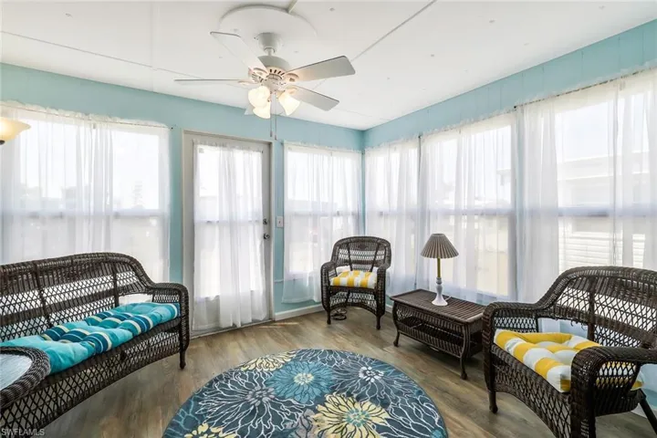 Sunroom / solarium with a wealth of natural light and wood finished floors