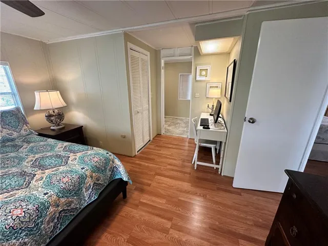 Bedroom with a closet, hardwood / wood-style floors, and ceiling fan