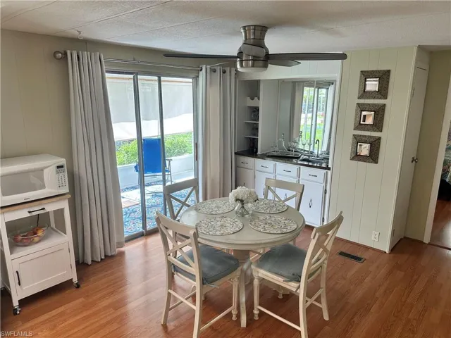 Dining space with a healthy amount of sunlight, a textured ceiling, light hardwood / wood-style flooring, and ceiling fan