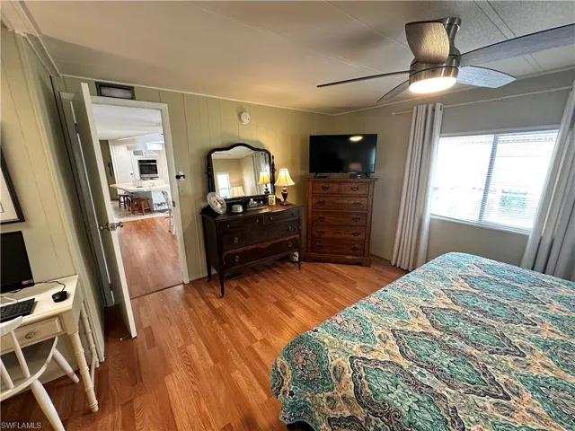 Bedroom with ceiling fan and light hardwood / wood-style flooring