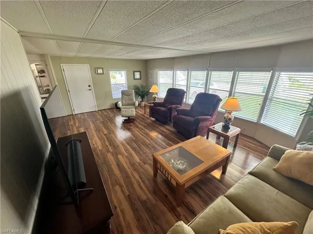 Living room featuring a textured ceiling and hardwood / wood-style floors
