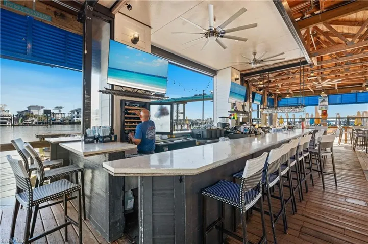 Community bar area with a ceiling fan