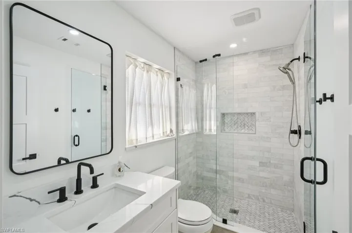 Bathroom featuring vanity and a shower stall