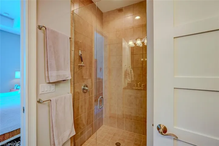 Full bath featuring ensuite bathroom and a shower stall