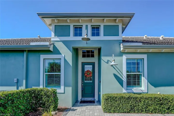 Doorway to property featuring stucco siding