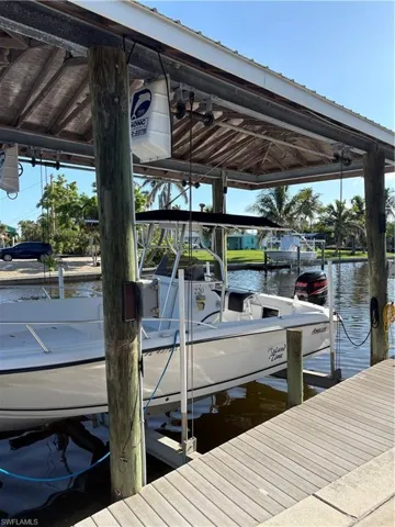 Dock area featuring a water view and boat lift