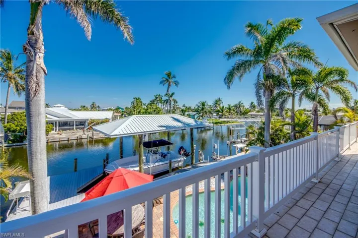 Dock area with a water view and a swimming pool