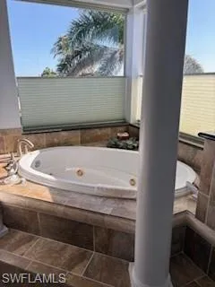 Bathroom with a whirlpool tub and ornate columns