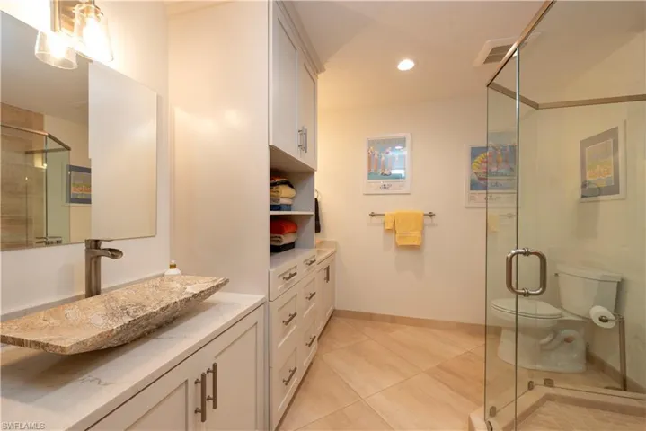 Bathroom featuring dual sinks and shower