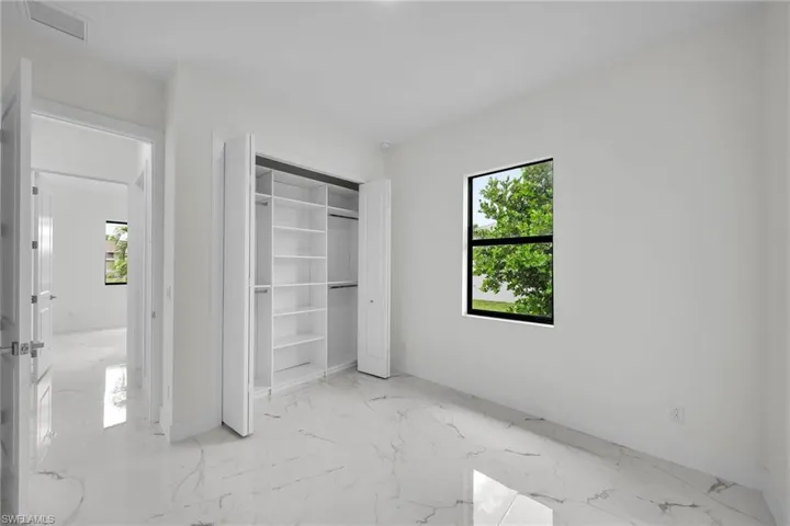 Unfurnished bedroom with light tile patterned floors and a closet