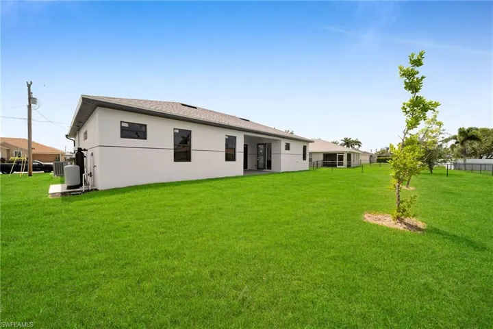 Rear view of house with a lawn