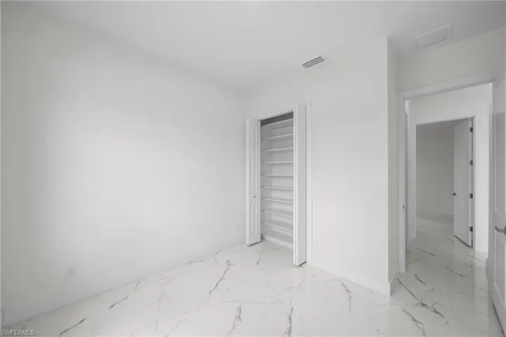Unfurnished bedroom featuring a closet and tile patterned floors