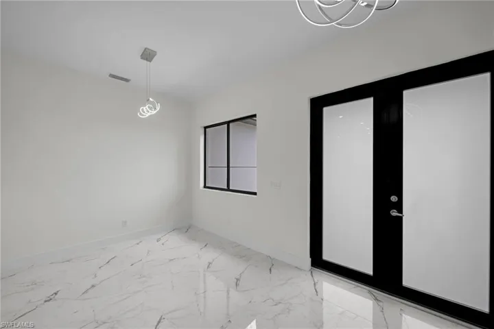 Empty room featuring tile patterned floors