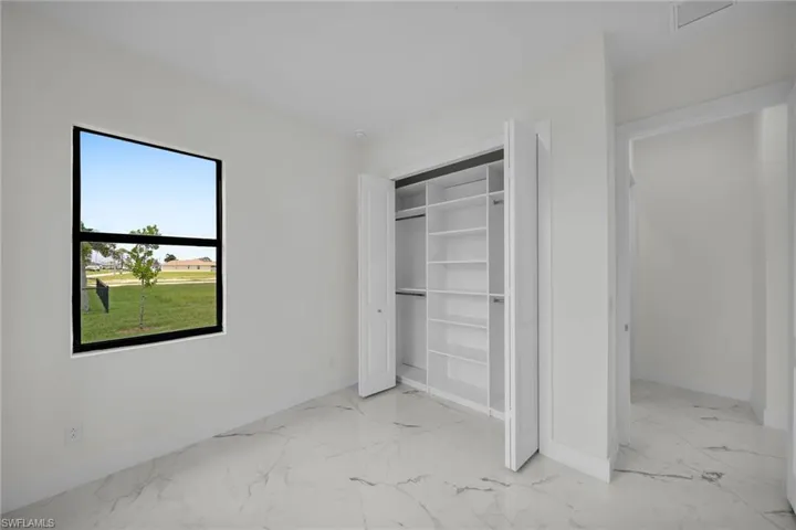 Unfurnished bedroom with a closet and light tile patterned floors