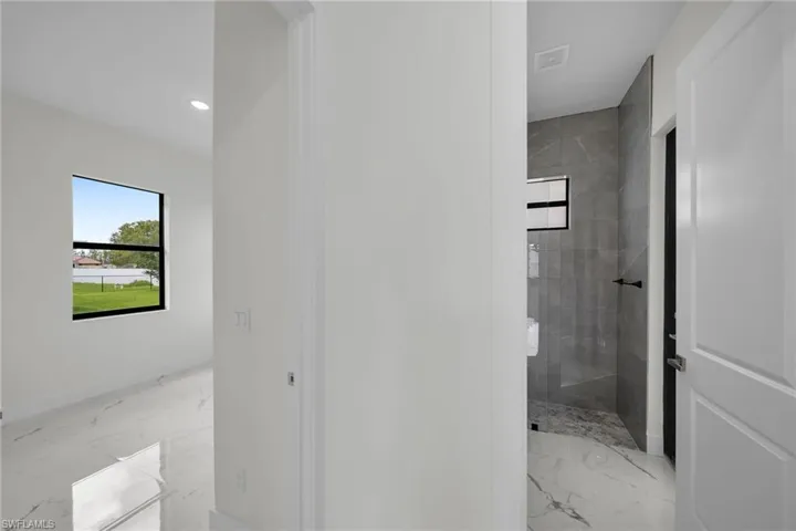 Bathroom featuring tile patterned flooring and a tile shower