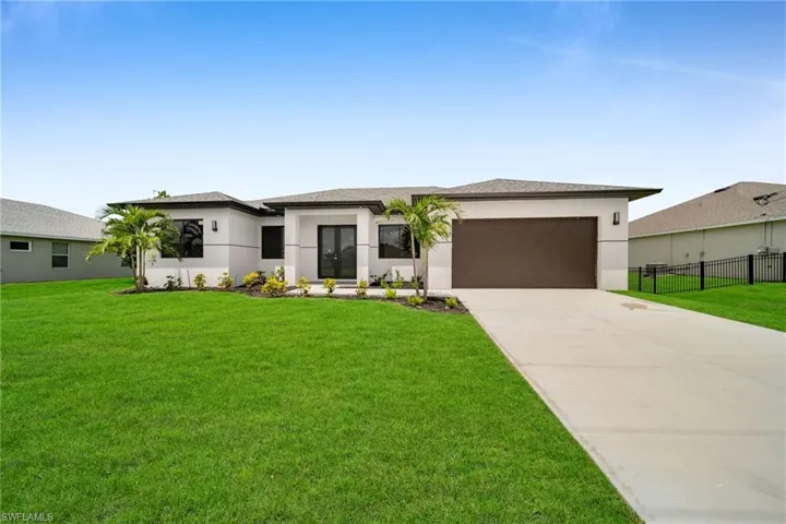 Prairie-style home featuring a garage and a front yard