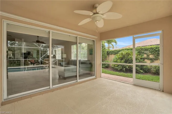 Unfurnished sunroom with ceiling fan