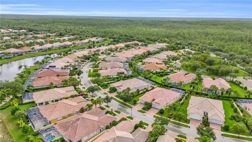 Birds eye view of property with a water view
